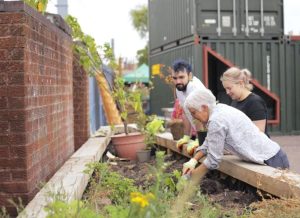 Woman digging in community garden